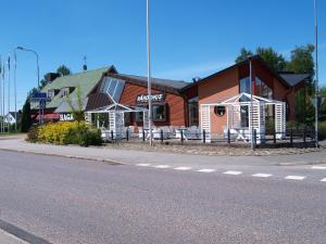 a building on the side of a street with a street at Haga Värdshus in Hillerstorp