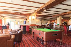a billiard room with couches and a pool table at Bowood Park Hotel in Camelford