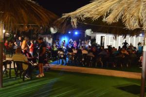 a crowd of people sitting in chairs at a concert at Residence Riviera in Alba Adriatica +75 photos