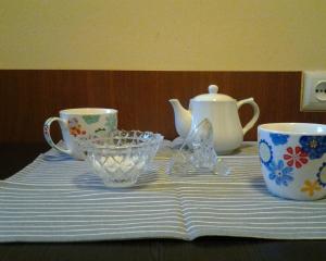 a table with three cups and a tea set on it at Old Tbilisi Flavor for you2 in Tbilisi City +7 photos