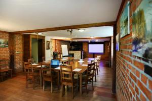 a dining room with tables and chairs and a tv at Willa Kazimiera in Kazimierz Dolny