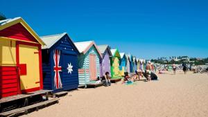 a row of colorful beach huts on the beach at Motel Schmotel in Brighton & Hove