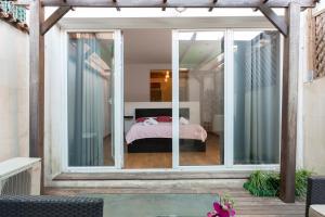 バルセロナにある1229 - AWESOME CITY CENTER APARTMENT WITH TERRACEのベッドルームにつながるガラスのスライドドア付きの部屋