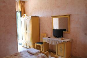 a bedroom with a dresser and a mirror at Hotel La Villa in Ceccano