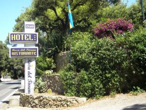 a sign for a hotel on the side of a street at Hotel Rosa Del Tirreno in Quercianella