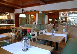 a restaurant with tables and chairs and a bar at Hotel Gasthof Sternen in Geisingen