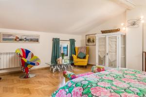 a bedroom with a bed and a table and a chair at Villa Vilma in Opatija