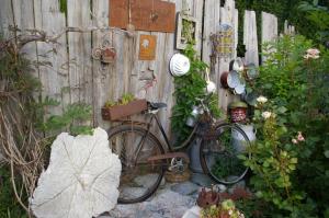 a bike parked next to a fence with plants at Thalerhof in Roppen