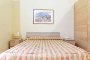 a bedroom with a bed and two night stands at Sunny Home in Rome