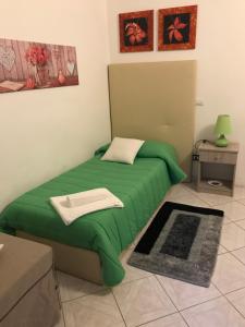 A bed or beds in a room at AFFITTACAMERE Il Cortile