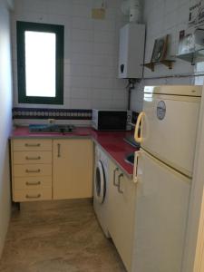a small kitchen with a refrigerator and a sink at Estudio San Felipe in Cádiz
