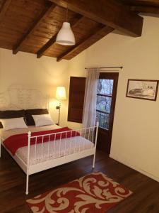 - une chambre avec un lit blanc et une fenêtre dans l'établissement Rose Cottage Tuscany, à Fosdinovo