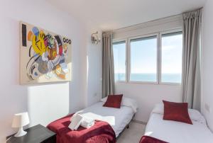 a bedroom with two beds and a window at 1410 - Mediterranean Forum Apartment in Barcelona