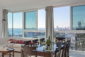 a living room with a couch and a table and chairs at 1410 - Mediterranean Forum Apartment in Barcelona