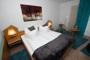 Postel nebo postele na pokoji v ubytování Paulin Hotel Trier