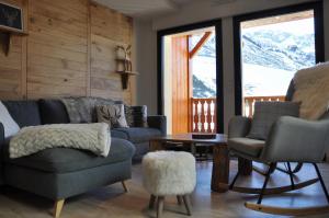 a living room with couches and chairs and a table at Appt Le Caribou/La Mongie in La Mongie