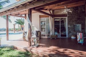 a house with a patio with a ceiling fan at Villa d’ô in Majikavo Koropa