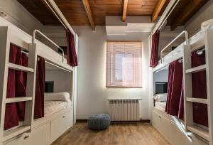 a room with two bunk beds and a window at Bercianos1900 in Bercianos del Real Camino