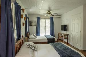 a bedroom with two beds and a ceiling fan at Coffee Mountain Inn in Santa Fé