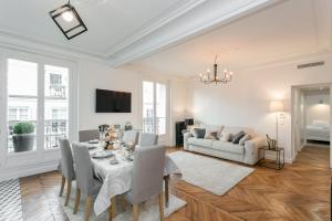 a living room with a table and a couch at La Résidence du Sénateur in Paris