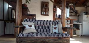 un sofá con almohadas en la cocina en Cabaña del Cielito - Complejo El Taller en Potrerillos