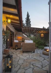 a patio with couches and chairs on a stone patio at Tritonia in Gaios