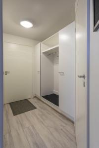 an empty room with a door and a closet at Tuomas´ luxurious suites, Ahola in Rovaniemi