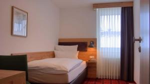 Postel nebo postele na pokoji v ubytování Hotel Kammerer