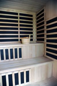 a wooden sauna with a bowl on a shelf at Arany Szőlő Wellness Apartmanház in Hévíz