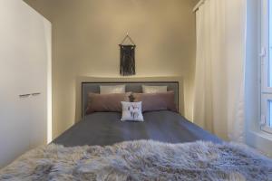 a bedroom with a bed with a furry blanket at Tuomas´ luxurious suites, Livo in Rovaniemi