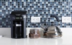 a kitchen counter with a coffee maker and a tea kettle at Azura Boutique Hotel in Tulum