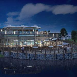 a restaurant with tables and umbrellas in front of a building at 3 bedroom caravan with hot tub Tattershall lakes in Tattershall