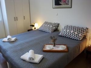 a bedroom with a bed with towels and a tray at Apartments Olea in Pinezici
