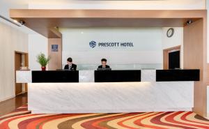 two people are sitting at a table in a room at Prescott Hotel Kuala Lumpur Medan Tuanku in Kuala Lumpur
