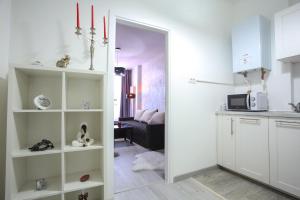 a kitchen with a door leading to a living room at Simona Maria in Bucharest