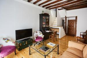 a living room with a couch and a table at Ático duplex con terraza en puro centro, 2 a 8 pax in Madrid