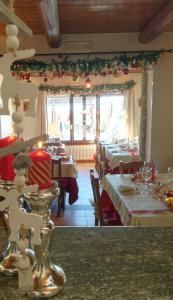 a dining room with tables and christmas decorations at Da Fabiana in Bossolasco