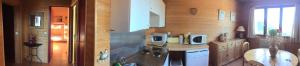 a kitchen with a stove and a microwave at La Moraine in Villard-de-Lans