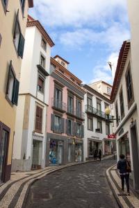 a cobblestone street in a town with buildings at Apartamentos Funchal by Petit Hotels in Funchal