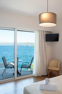 a bedroom with a view of the ocean at Karalis Beach in Pylos