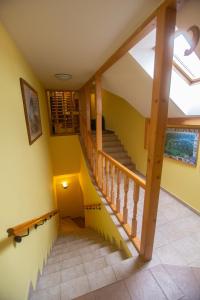 a staircase in a house with yellow walls at Penzion Moyzes in Banská Bystrica