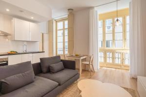 a living room with a couch and a kitchen at LU&CIA SOHO free breakfast! in Málaga