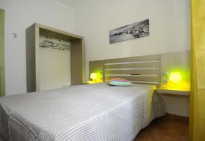 a bedroom with a bed with two lamps on it at Rossio in Albufeira