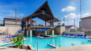 a swimming pool with blue chairs in a swimming pool at Grand Islander Hotel in Put-in-Bay