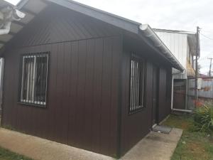 a black building with windows on the side of it at Cabañas Arlenne in Valdivia