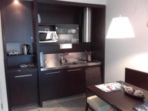 a small kitchen with a sink and a microwave at klass 203 in Kranjska Gora