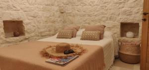 A bed or beds in a room at Trullo la perla di pietra