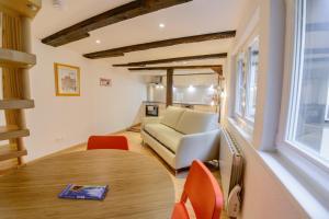 a living room with a table and a couch at Cosy & quiet flat in historical lively center of Strasbourg in Strasbourg