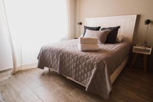 a bedroom with a bed with a pillow on it at Casa Nuestra in Cordoba