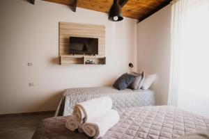 a bedroom with two beds and a tv on the wall at Casa Nuestra in Córdoba